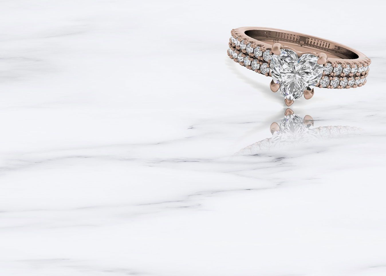 rose gold heart-shaped diamond ring on marble