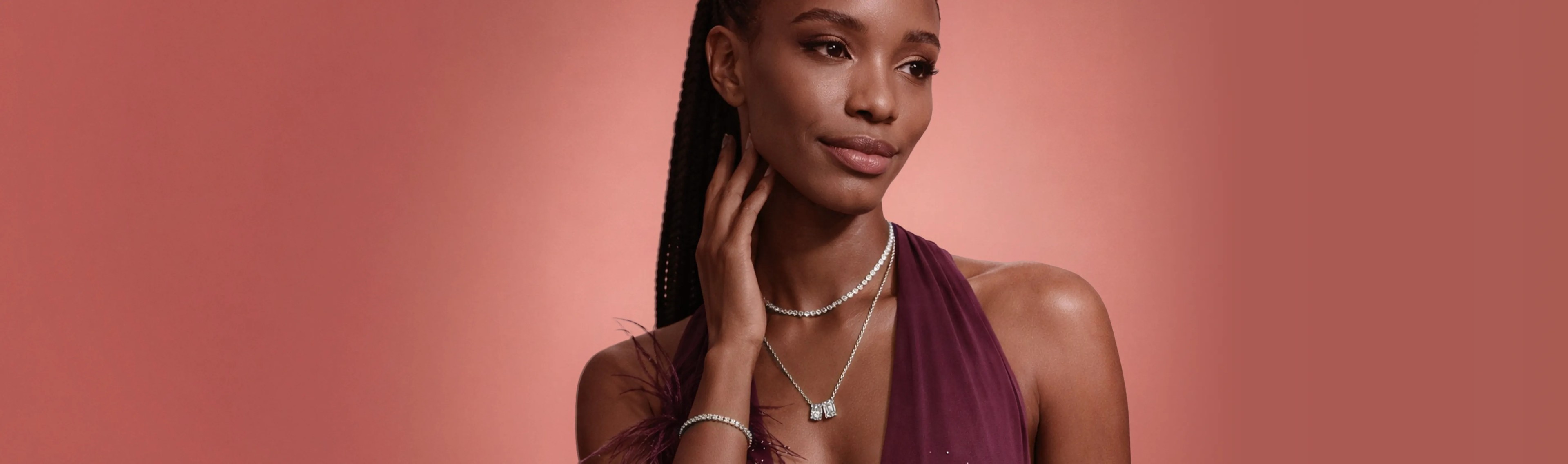 Woman wearing Diamond Jewelry, tennis necklace, tennis bracelet, and two stone diamond pendant