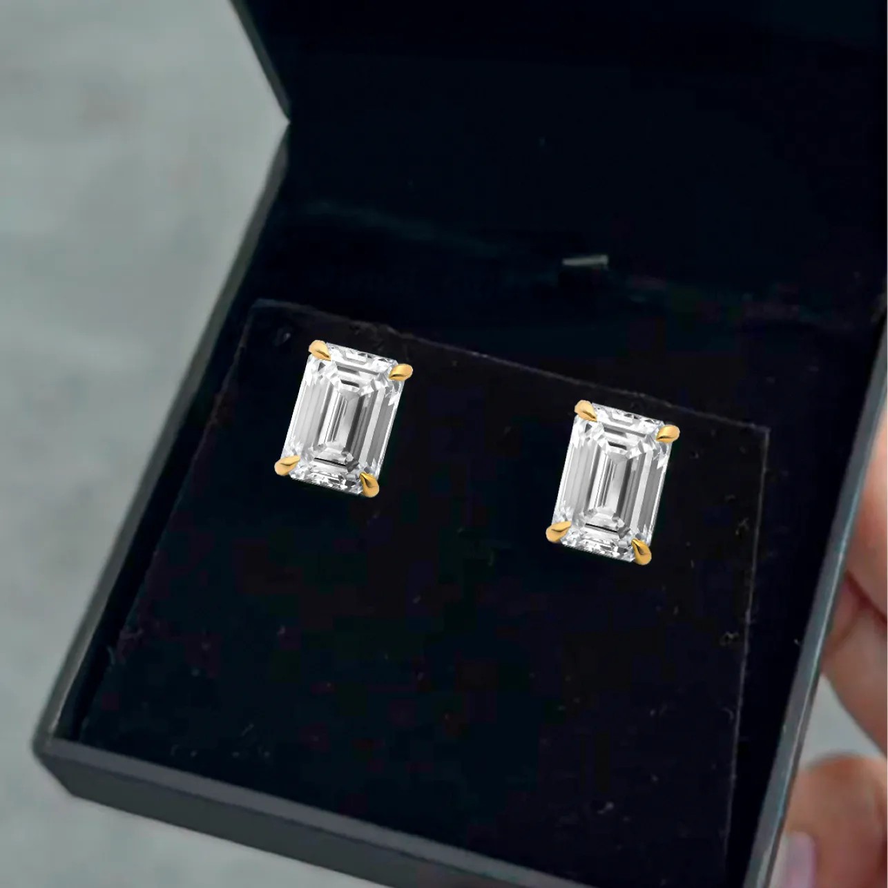 Emerald cut diamond stud earrings in 18kt Yellow Gold in a Black Ritani Jewelry Box