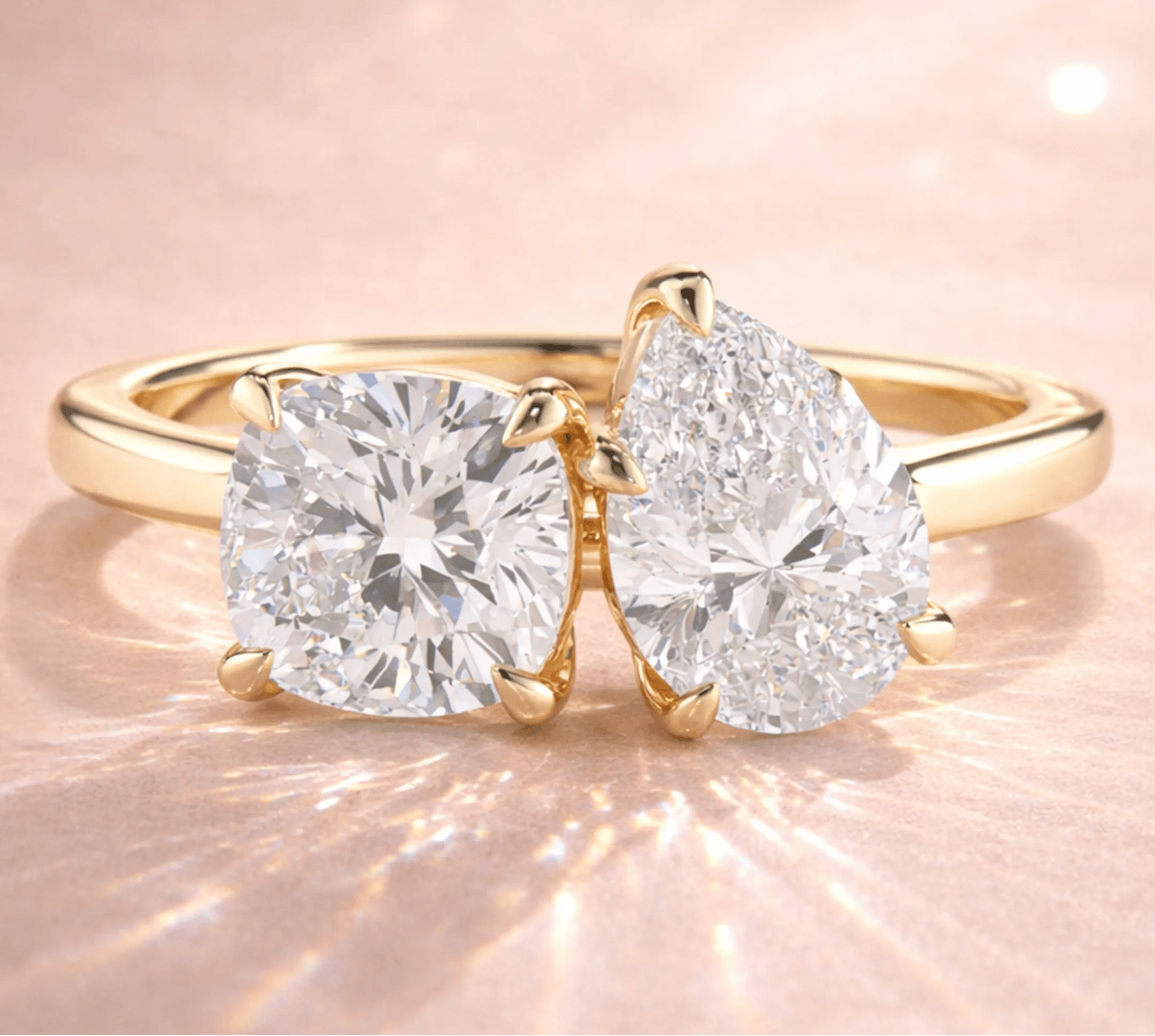 Two stone yellow gold diamond engagement ring with cushion cut and pear cut diamonds