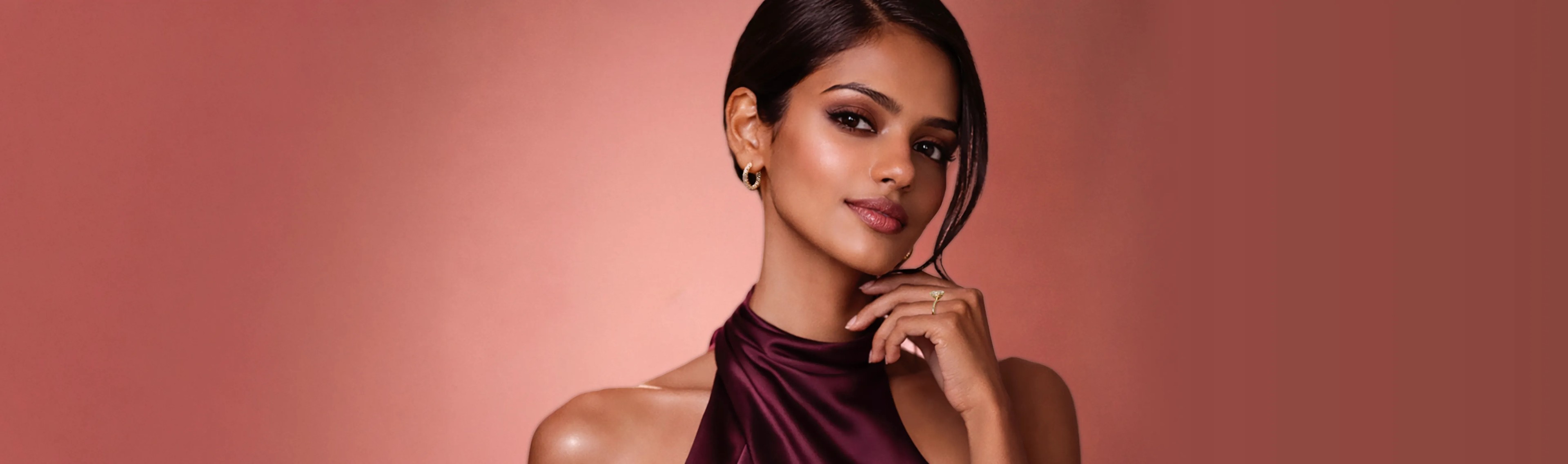 Woman wearing A tennis Bracelet, round engagement ring and in and out diamond hoop earrings all in Yellow Gold