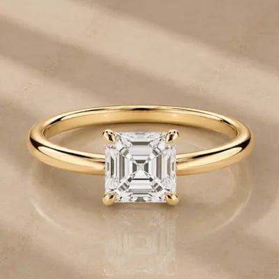 asscher cut solitaire engagement ring on neutral background