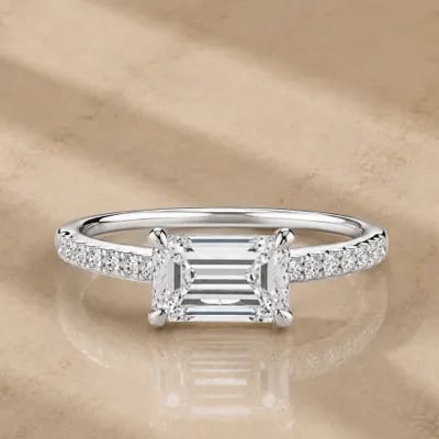 east to west engagement ring on neutral background