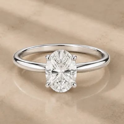 oval cut solitaire engagement ring on neutral background