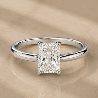 radiant cut solitaire engagement ring on neutral background