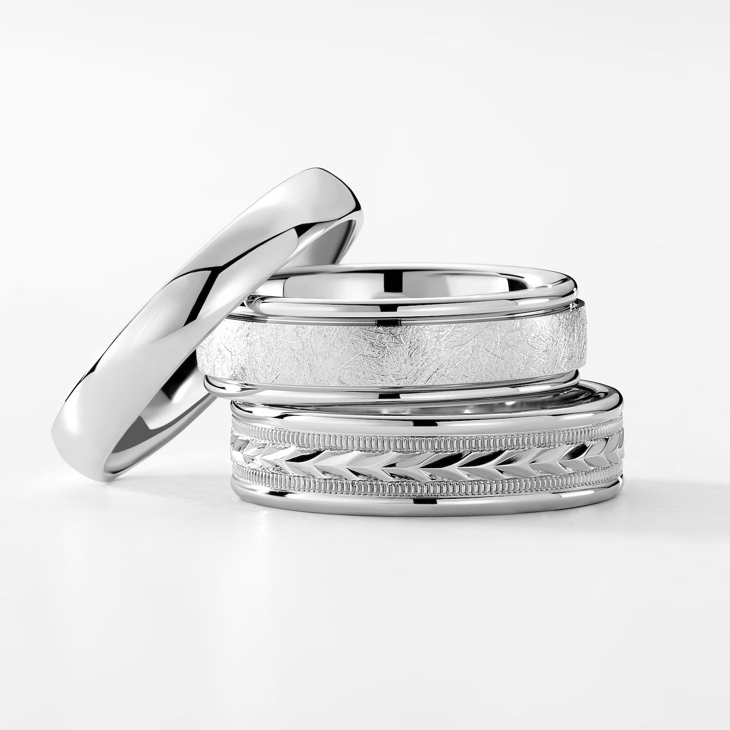 men's wedding rings stacked on top of each other