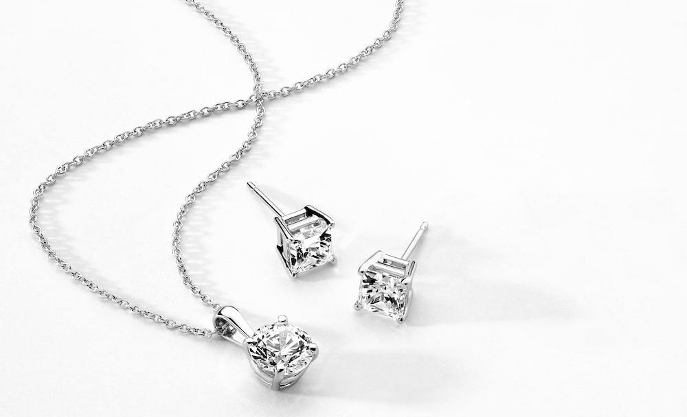 white gold diamond pendant and diamond stud earrings