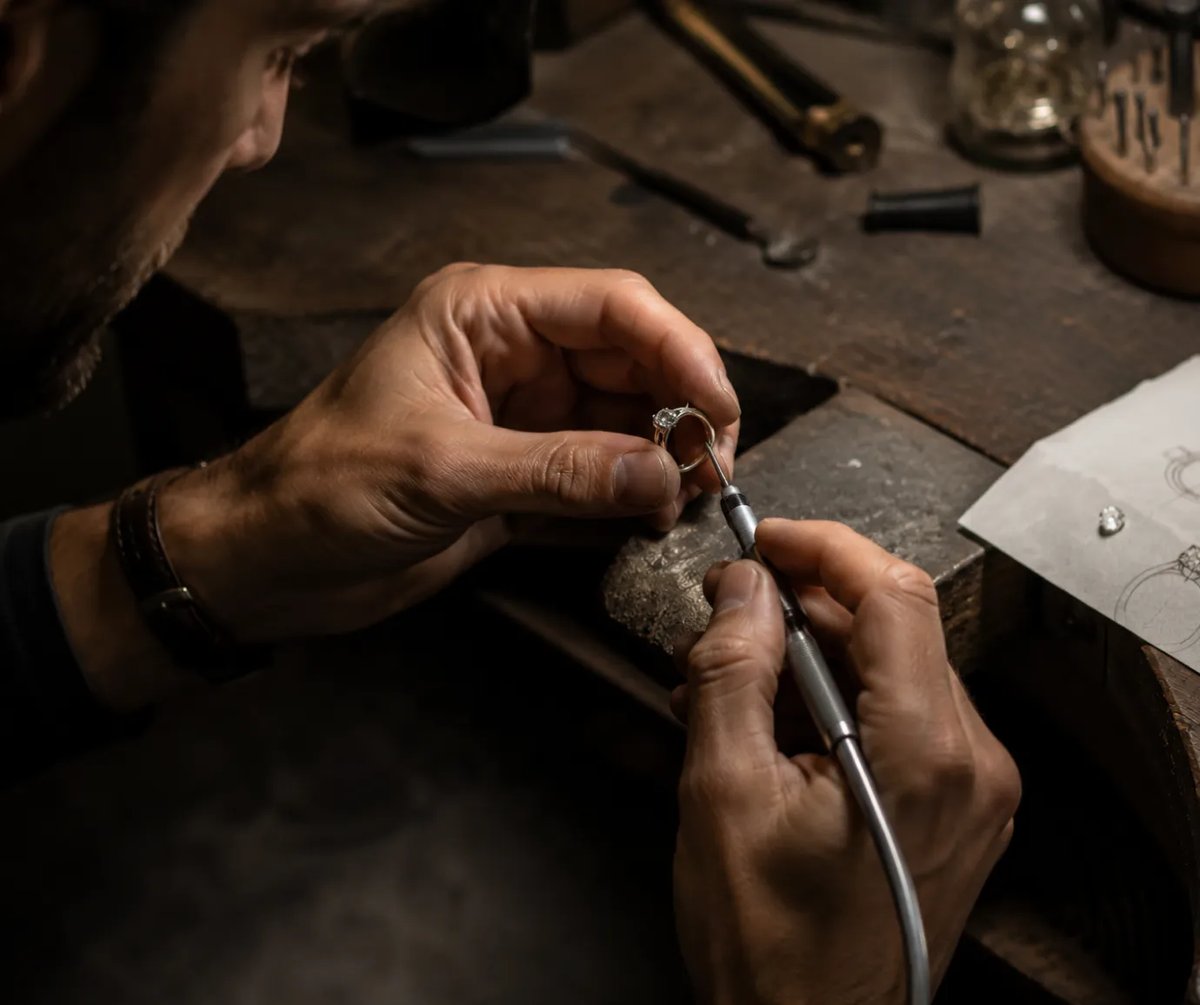 person crafting an engagement ring at a workbench