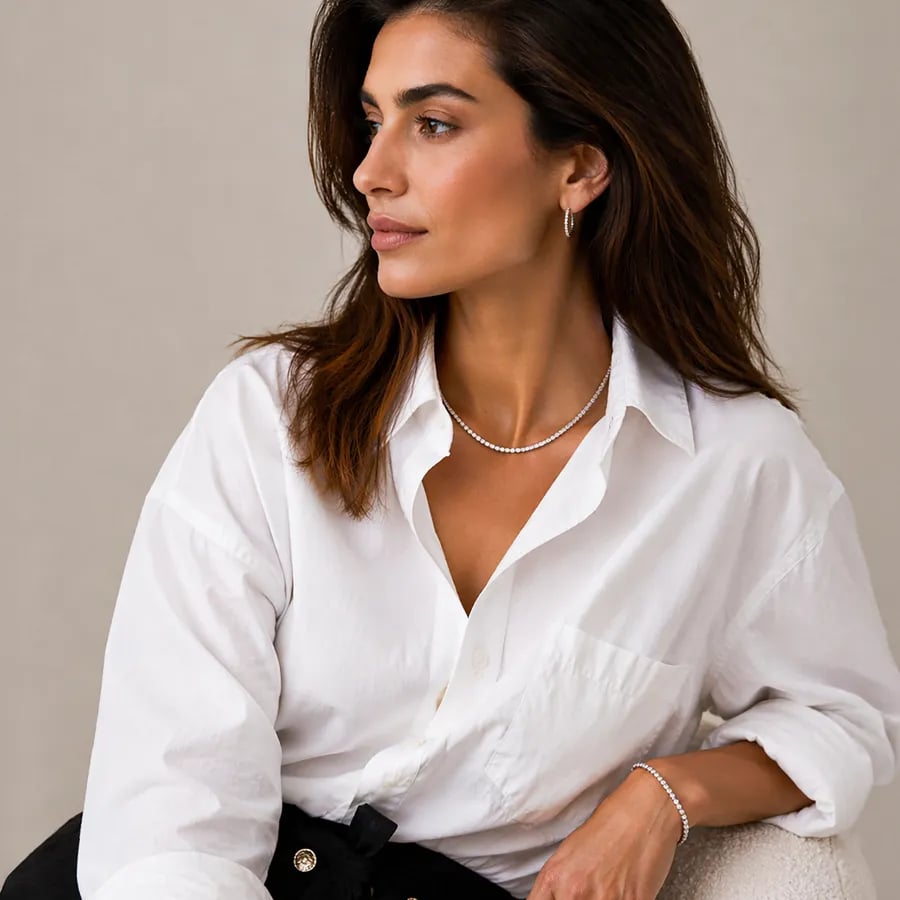 woman wearing diamond jewelry in white shirt